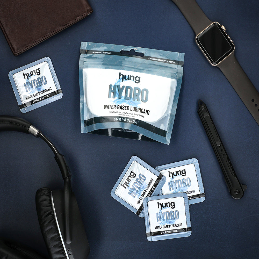 Hung Hydro Water-Based Snap + Slide™ Multiple Packs and Bag laying with headphones and watch